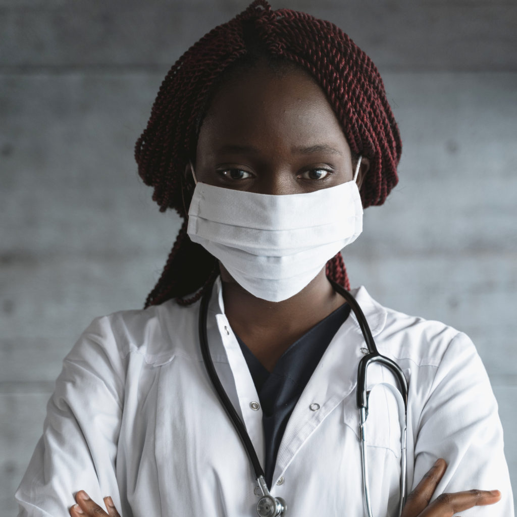 Doctor wearing mask, lab coat, and stethoscope